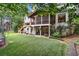 Spacious backyard with a screened porch, lush lawn, and mature landscaping providing a serene and private outdoor space at 9595 Rod Rd, Alpharetta, GA 30022