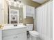 Bathroom featuring white fixtures, cabinets, and shower with open doorway to another room at 9595 Rod Rd, Alpharetta, GA 30022