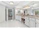 Bathroom with granite counters, a mirrored wall, and a stool at 9595 Rod Rd, Alpharetta, GA 30022