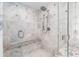 Beautiful bathroom with a spacious glass shower, marble tile and stone bench seating at 9595 Rod Rd, Alpharetta, GA 30022