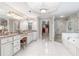 Bright bathroom features white cabinetry, granite counters, a glass-enclosed shower, and a walk-in closet at 9595 Rod Rd, Alpharetta, GA 30022