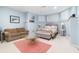 Basement bedroom with blue walls, neutral furniture, and plenty of natural light at 9595 Rod Rd, Alpharetta, GA 30022