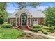 Exterior of the community clubhouse, featuring a brick facade, arched entrance, and well-maintained landscaping at 9595 Rod Rd, Alpharetta, GA 30022