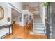 Traditional foyer with wood floors, stairs, and views to other rooms is warm and inviting at 9595 Rod Rd, Alpharetta, GA 30022