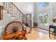 Spacious foyer features wood flooring and staircase with iron balusters leading to the upper level at 9595 Rod Rd, Alpharetta, GA 30022