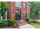 Close-up of the brick home’s front door with beautiful wreaths and manicured landscaping at 9595 Rod Rd, Alpharetta, GA 30022