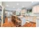 Spacious kitchen featuring an island with bar stool seating, stainless steel appliances, and ample cabinet space at 9595 Rod Rd, Alpharetta, GA 30022