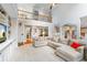 Open-concept living room with high ceilings, cozy sectional sofa, and a view of the upstairs railing at 9595 Rod Rd, Alpharetta, GA 30022