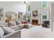 Spacious living room with high ceilings, a fireplace, large windows, and open access to the kitchen at 9595 Rod Rd, Alpharetta, GA 30022