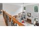 Open-concept living room featuring soaring ceilings, fireplace, an adjacent kitchen, and plenty of natural light at 9595 Rod Rd, Alpharetta, GA 30022