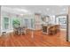 Open layout featuring kitchen island and dining area, with abundant natural light at 9595 Rod Rd, Alpharetta, GA 30022
