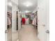 Large walk-in closet with carpet, ample shelving, and mirrors to maximize space at 9595 Rod Rd, Alpharetta, GA 30022