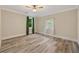 Bright bedroom featuring gray laminate flooring, neutral walls, ceiling fan, and two windows allowing natural light at 1268 Ladd Sw St, Atlanta, GA 30310