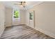 Bright bedroom with two windows, a ceiling fan, and vinyl flooring at 1268 Ladd Sw St, Atlanta, GA 30310