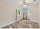Neutral bedroom with two windows, ceiling fan, and wood-look floors at 1268 Ladd Sw St, Atlanta, GA 30310