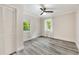 Cozy bedroom with neutral walls, ceiling fan, and two bright windows at 1268 Ladd Sw St, Atlanta, GA 30310