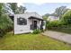 Cozy home with well-maintained lawn, black accents, and a paved driveway leading to the entrance at 1268 Ladd Sw St, Atlanta, GA 30310