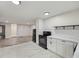 Bright kitchen boasts white cabinets, black appliances, and updated flooring at 1268 Ladd Sw St, Atlanta, GA 30310