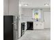 Modern kitchen with white cabinetry, black appliances, subway tile backsplash, and updated lighting at 1268 Ladd Sw St, Atlanta, GA 30310
