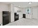 Updated kitchen featuring white cabinets, black hardware, subway tile, and a view to the backyard at 1268 Ladd Sw St, Atlanta, GA 30310