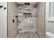 Detailed view of the shower with pebble flooring and subway tile surround at 1268 Ladd Sw St, Atlanta, GA 30310