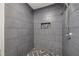 Walk-in shower with gray, textured tile, mosaic floor, and built-in niche at 1268 Ladd Sw St, Atlanta, GA 30310