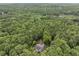 Stunning aerial view of home, surrounded by a canopy of trees, with lake in the distance at 1678 Rabke Rd, Canton, GA 30114