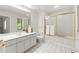 Bright bathroom features white cabinets, sink, toilet, tile floors, and shower with gold trim at 1678 Rabke Rd, Canton, GA 30114