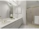 Bathroom with double sinks, shower with gold trim and skylight that brings in natural light at 1678 Rabke Rd, Canton, GA 30114