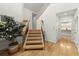 Light wood staircase with black metal railings, and hardwood floors by the front door at 1678 Rabke Rd, Canton, GA 30114