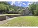 Back of home showing deck, stone retaining walls, and yard at 1678 Rabke Rd, Canton, GA 30114