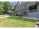 View of side and back of home showing yard with mature trees at 1678 Rabke Rd, Canton, GA 30114