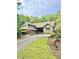 Charming home exterior featuring lush landscaping and a curved driveway at 1678 Rabke Rd, Canton, GA 30114