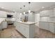 Modern white kitchen featuring stainless steel appliances and a central island with countertop seating at 1678 Rabke Rd, Canton, GA 30114