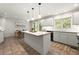 Spacious kitchen with white cabinets, center island, and tile flooring at 1678 Rabke Rd, Canton, GA 30114