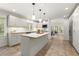 Bright kitchen featuring white cabinets, an island, tile flooring, and modern appliances at 1678 Rabke Rd, Canton, GA 30114