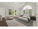 Vaulted main bedroom filled with natural light, with sitting area and neutral decor at 1678 Rabke Rd, Canton, GA 30114