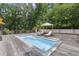 Home has a pool with lounge chairs and an umbrella on a wooden deck at 1678 Rabke Rd, Canton, GA 30114