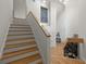 Wooden staircase with hardwood floors leads into the split-level home with white walls at 1678 Rabke Rd, Canton, GA 30114