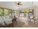 Charming sunroom with tile flooring, large windows, and access to the outdoor pool area at 1678 Rabke Rd, Canton, GA 30114