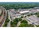Commercial buildings with ample parking and trees, near train tracks, offering convenient access and urban amenities at 178 Wesley Ne Ave # B, Atlanta, GA 30307