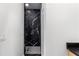 Narrow bathroom featuring a black-tiled shower with glass door at 178 Wesley Ne Ave # B, Atlanta, GA 30307