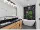Bathroom showcasing soaking tub, black marble tile, double vanity, and modern fixtures at 178 Wesley Ne Ave # B, Atlanta, GA 30307
