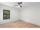 Bright bedroom features a ceiling fan and a window offering a lush green view at 178 Wesley Ne Ave # B, Atlanta, GA 30307
