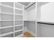 Spacious walk-in closet with ample white shelving and black rods for hanging clothes at 178 Wesley Ne Ave # B, Atlanta, GA 30307
