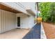Home's exterior side view with covered area and access to a backyard area with rock feature at 178 Wesley Ne Ave # B, Atlanta, GA 30307