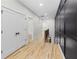 Hallway with hardwood floors and modern accent wall at 178 Wesley Ne Ave # B, Atlanta, GA 30307