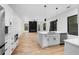 Open-concept kitchen with white cabinetry, marble countertops, and stainless steel appliances overlooking the living area at 178 Wesley Ne Ave # B, Atlanta, GA 30307