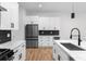 Modern kitchen featuring white cabinetry, marble countertops, a central island, and stainless steel appliances at 178 Wesley Ne Ave # B, Atlanta, GA 30307