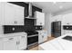 Updated kitchen with marble counters, modern cabinets, stainless appliances and black tile backsplash at 178 Wesley Ne Ave # B, Atlanta, GA 30307